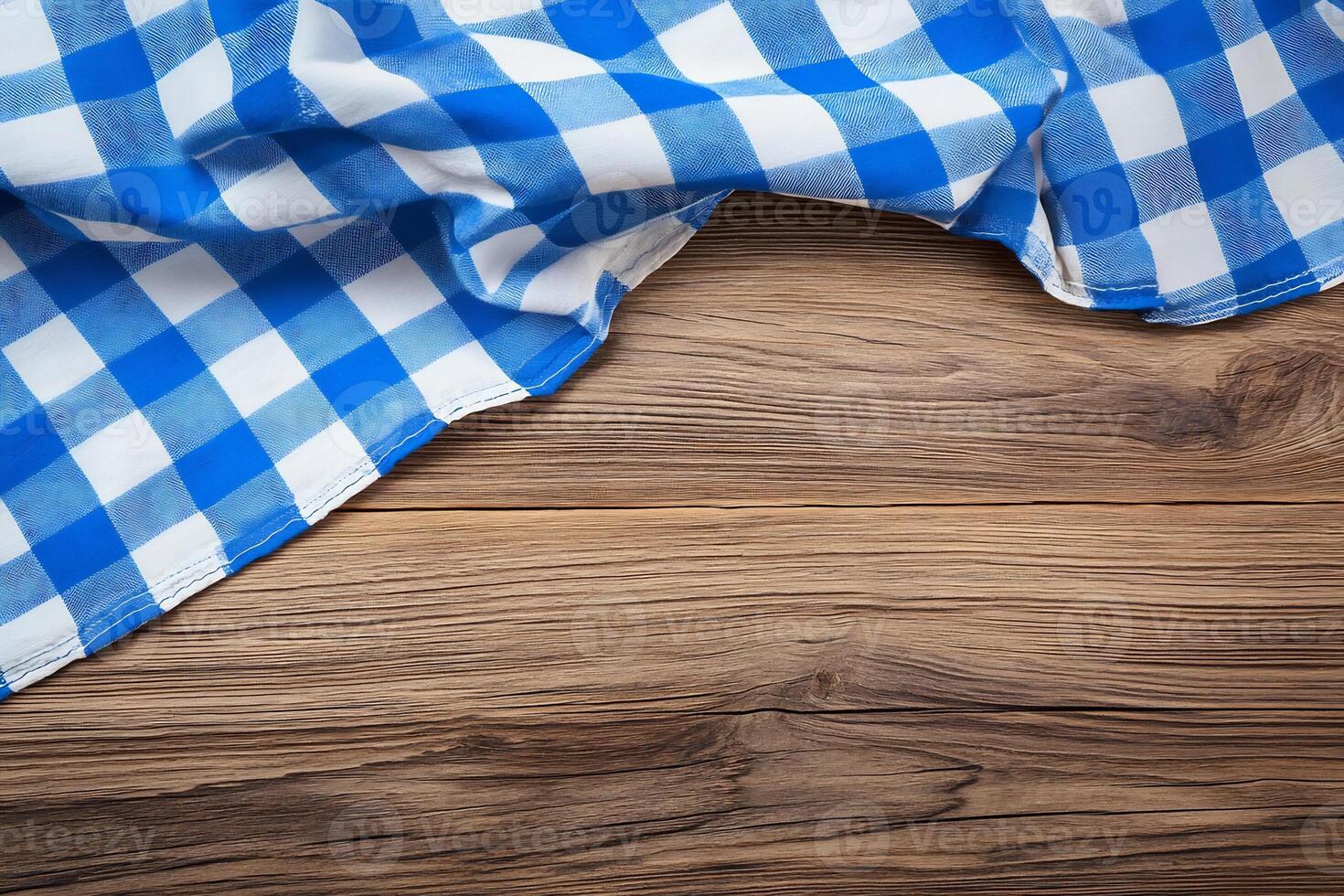 A blue and white checkered tablecloth on a wooden table photo