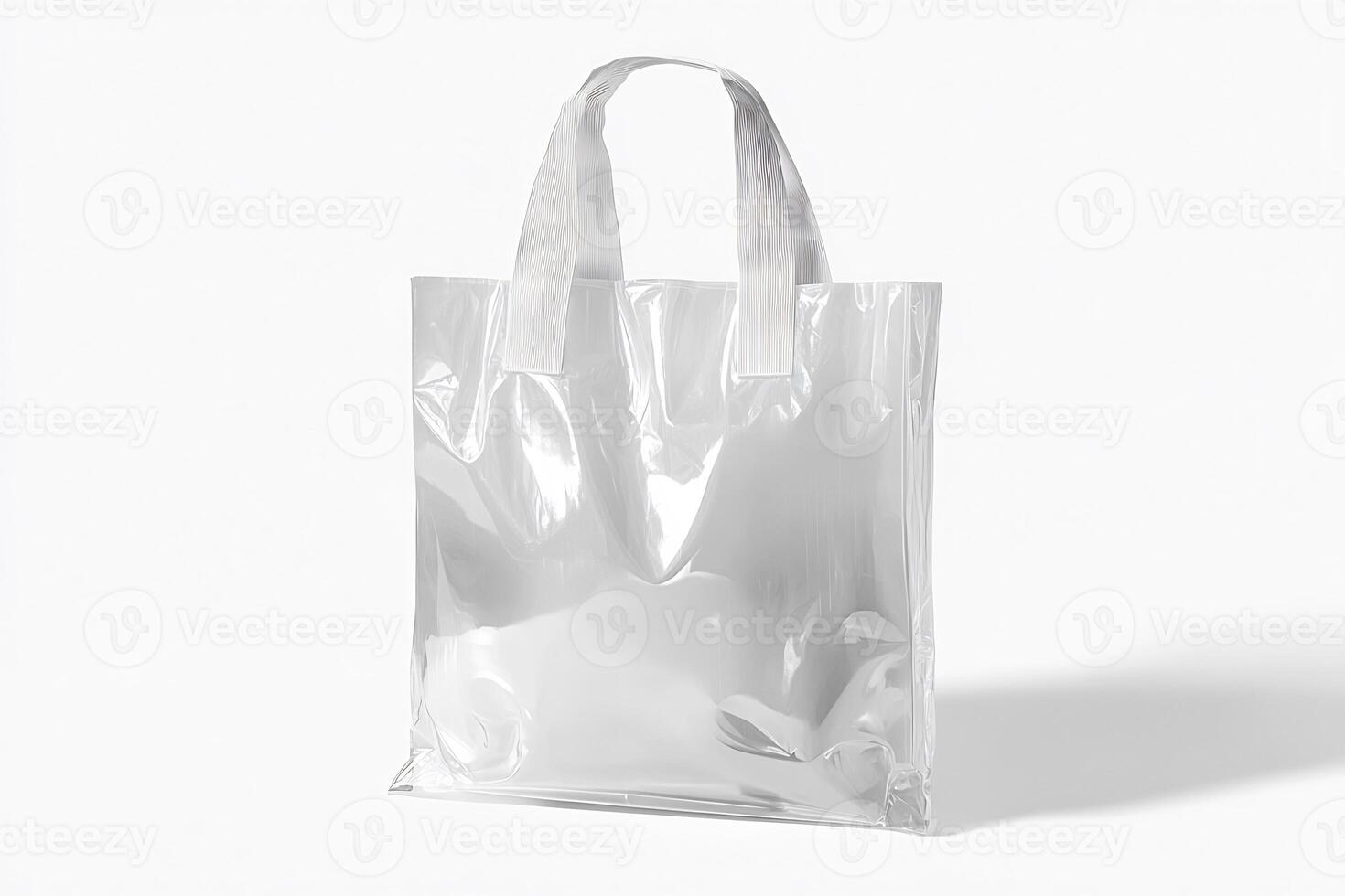 A clear plastic shopping bag on a white surface photo