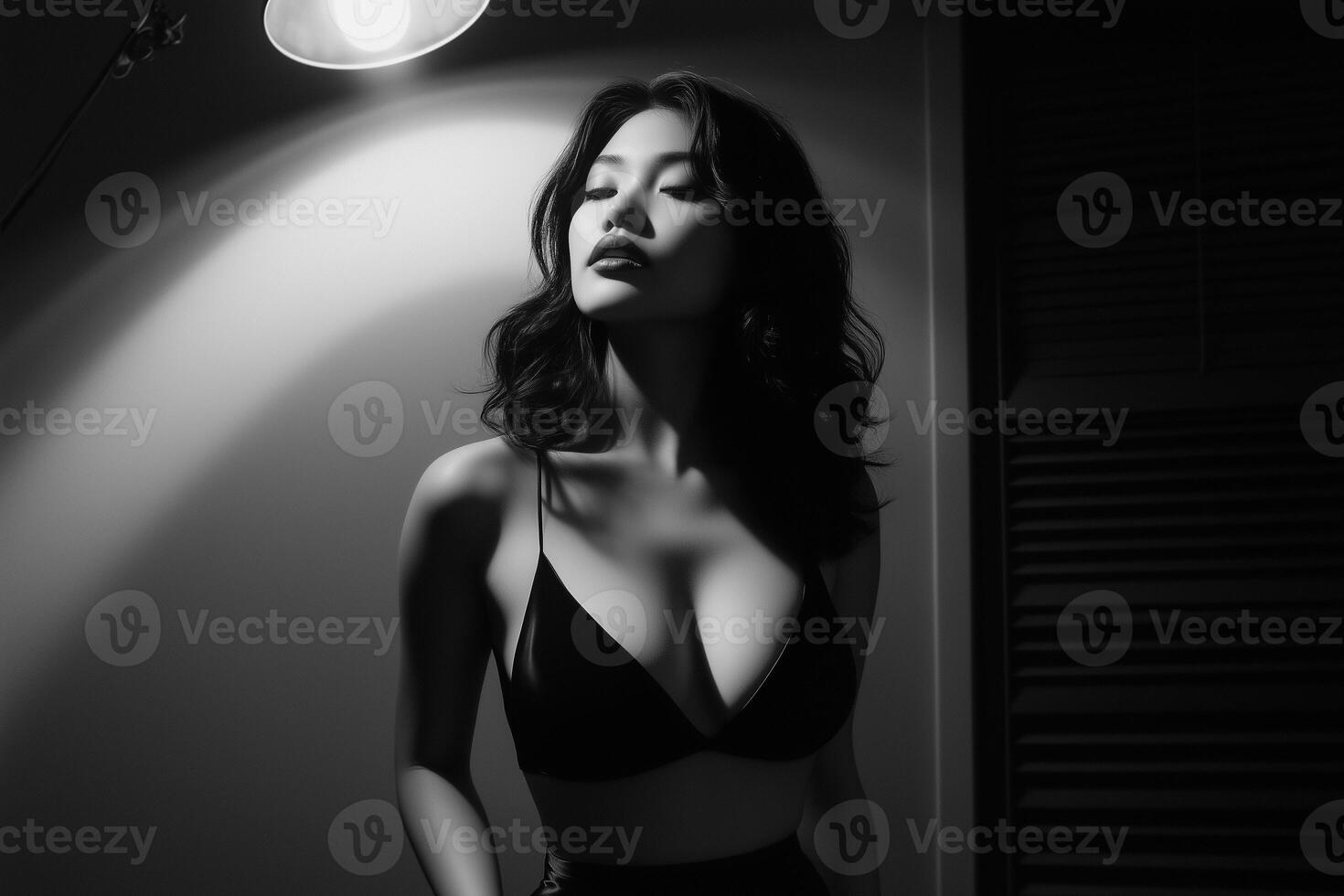 A black and white photo of a woman in a bra top