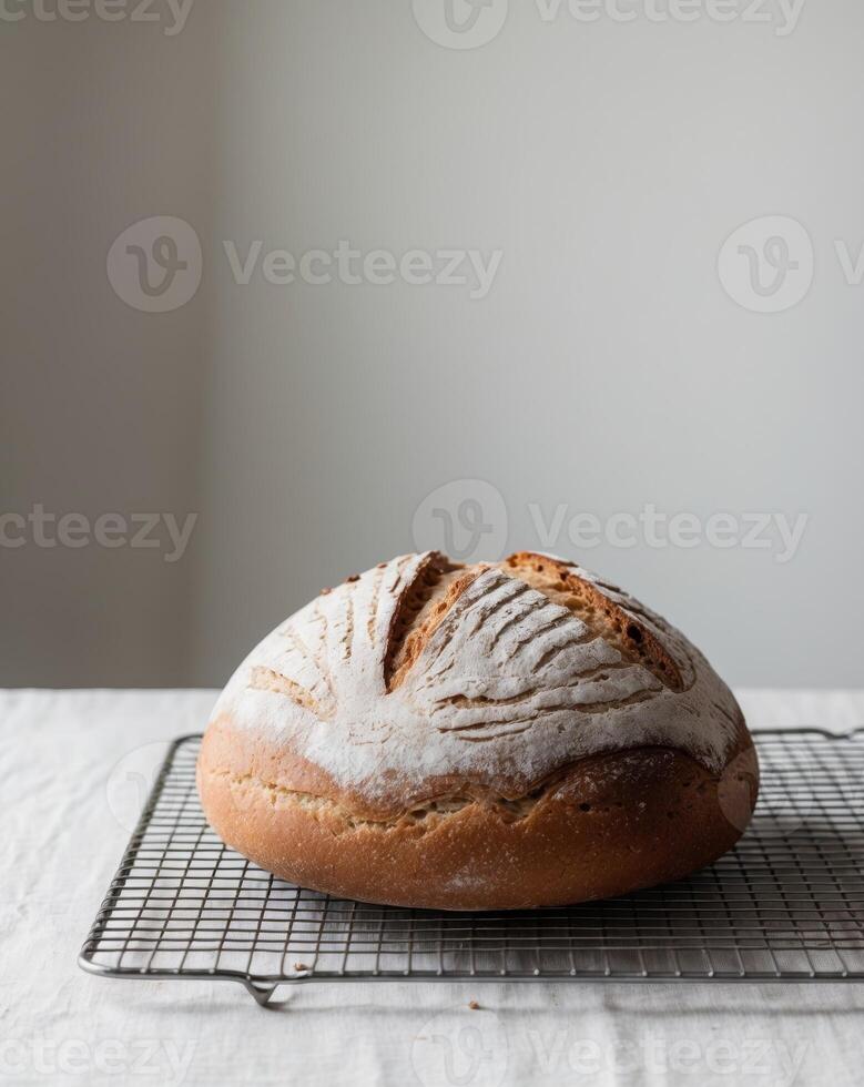 A loaf of bread on a cooling rack photo