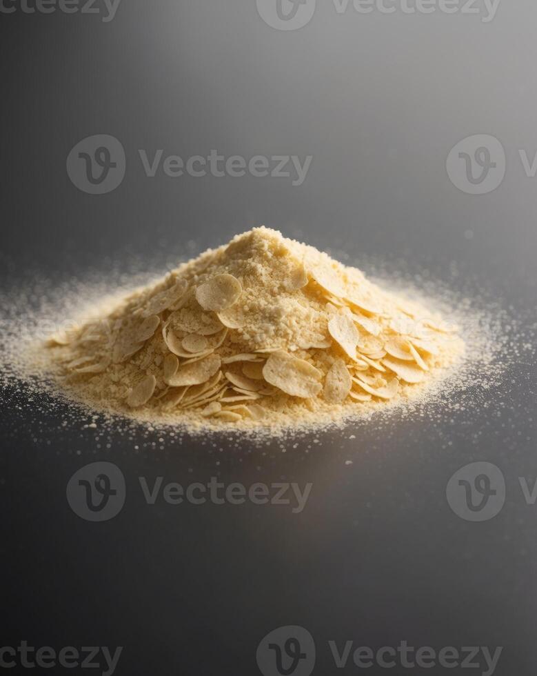 Nutritional Yeast Flakes Pile on Black Background with Fine Texture and Depth of Field photo