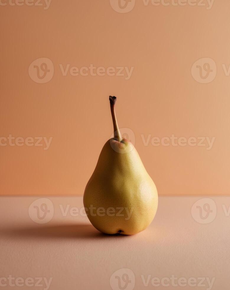 Ripe pear resting soft orange background photo