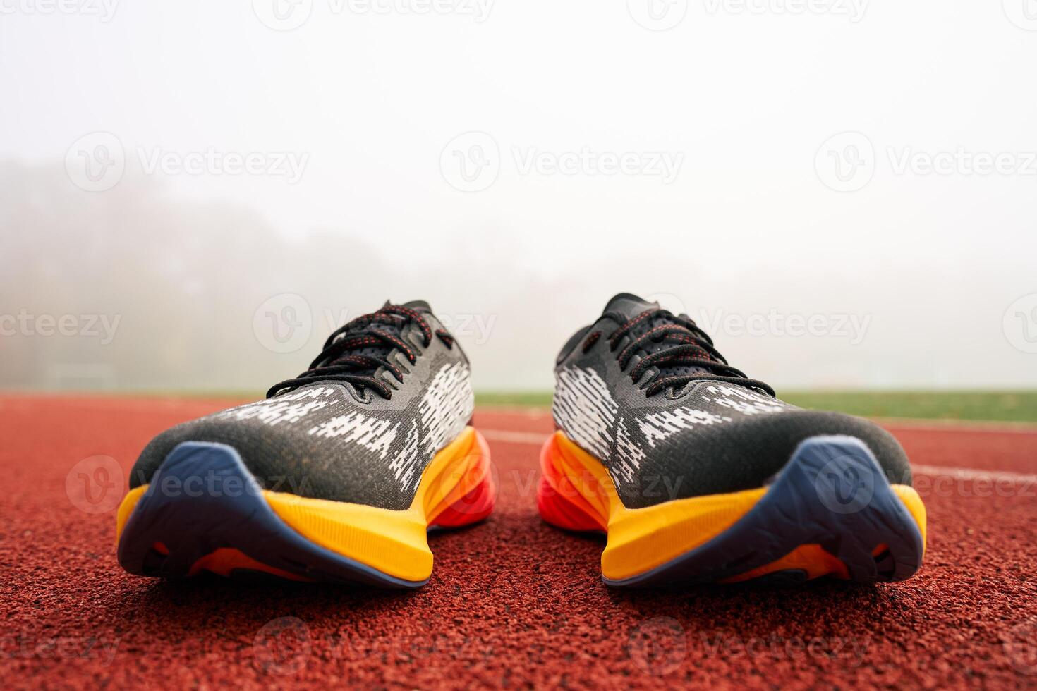 Colorful running shoes on red track photo