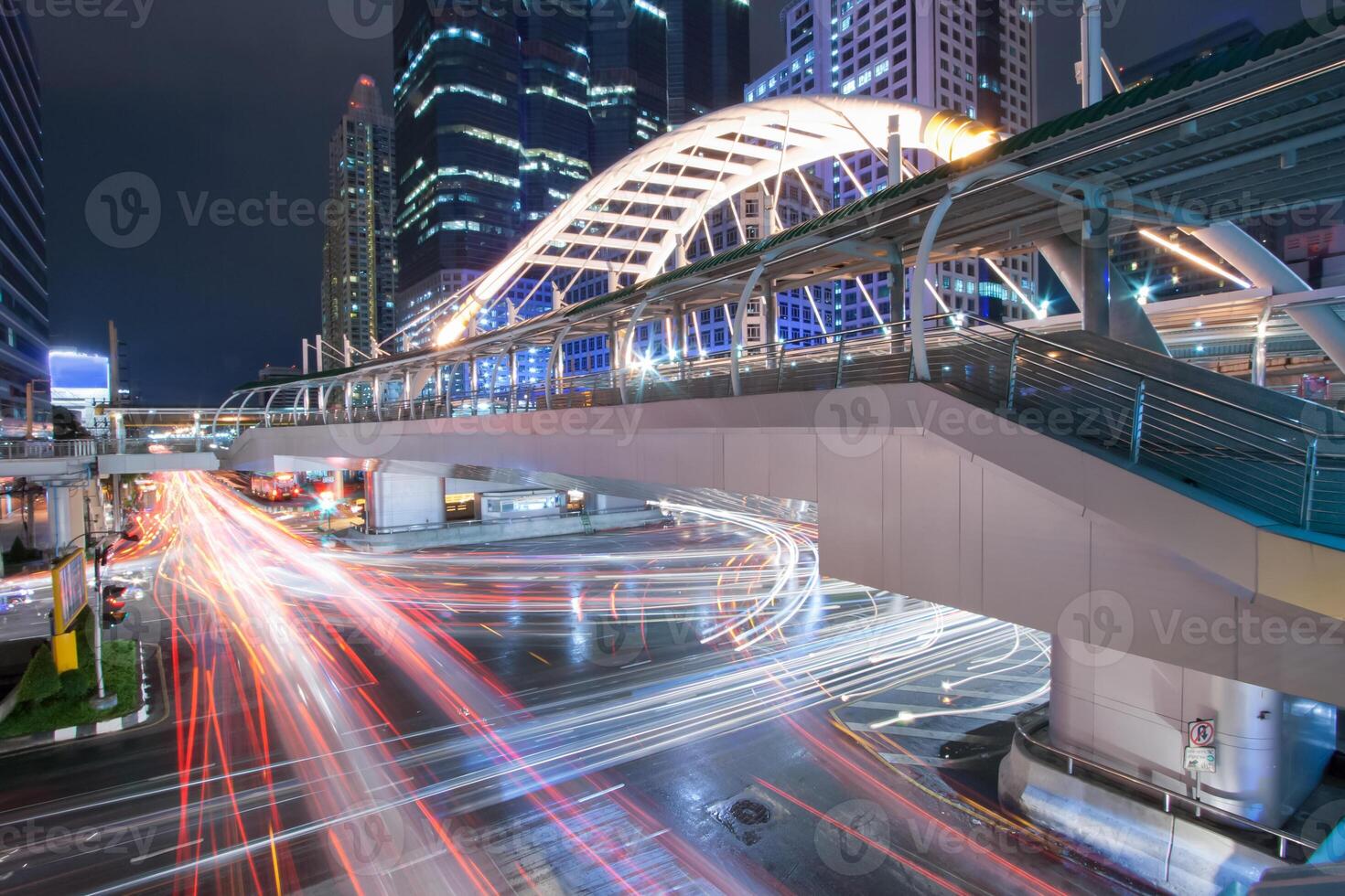 A city street at night with traffic lights photo