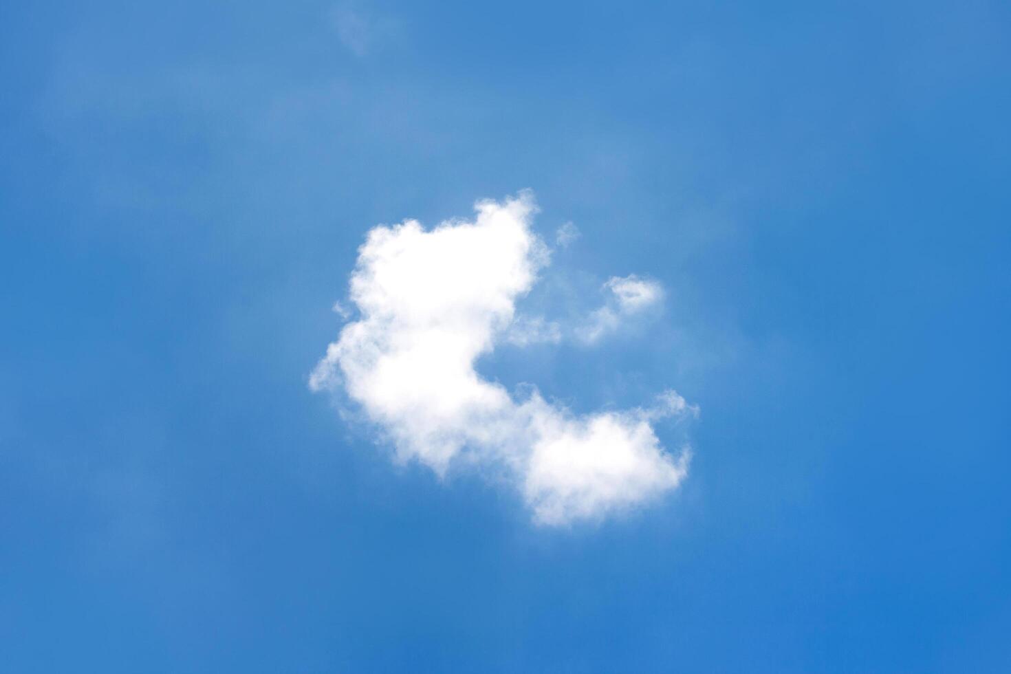 A cloud is in the sky with a blue sky photo