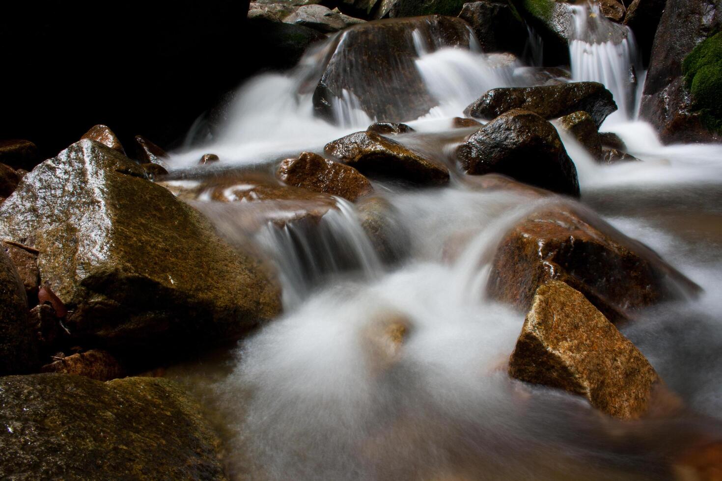 A waterfall flowing over rocks photo