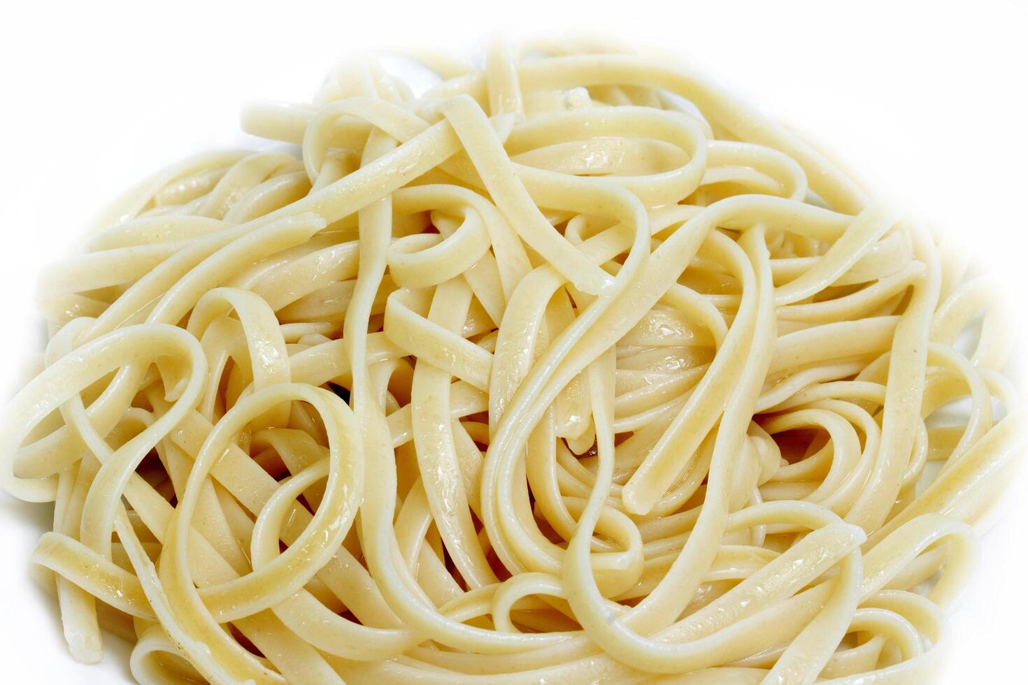 A pile of spaghetti noodles on a white background photo