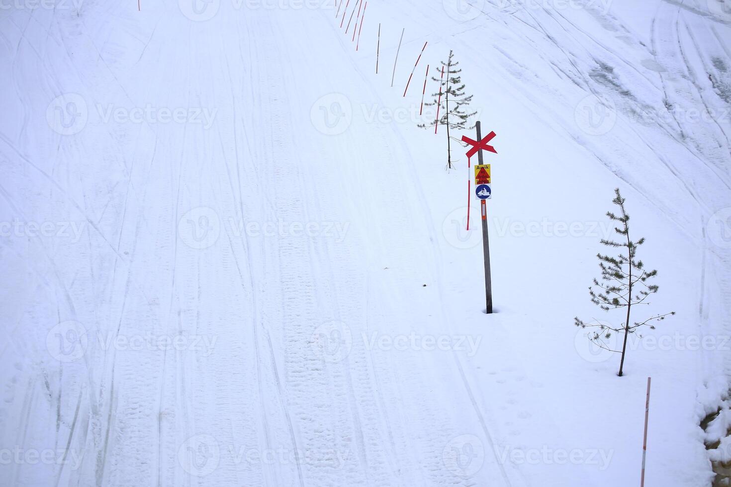 Snowmobile path in Lycksele, northern Sweden. The sign says - do not depart from path photo