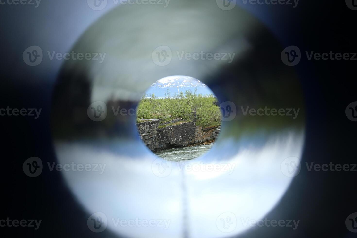 Unusual shot through a colored tube, a cliff at the stream Abiskojakka can be seen photo