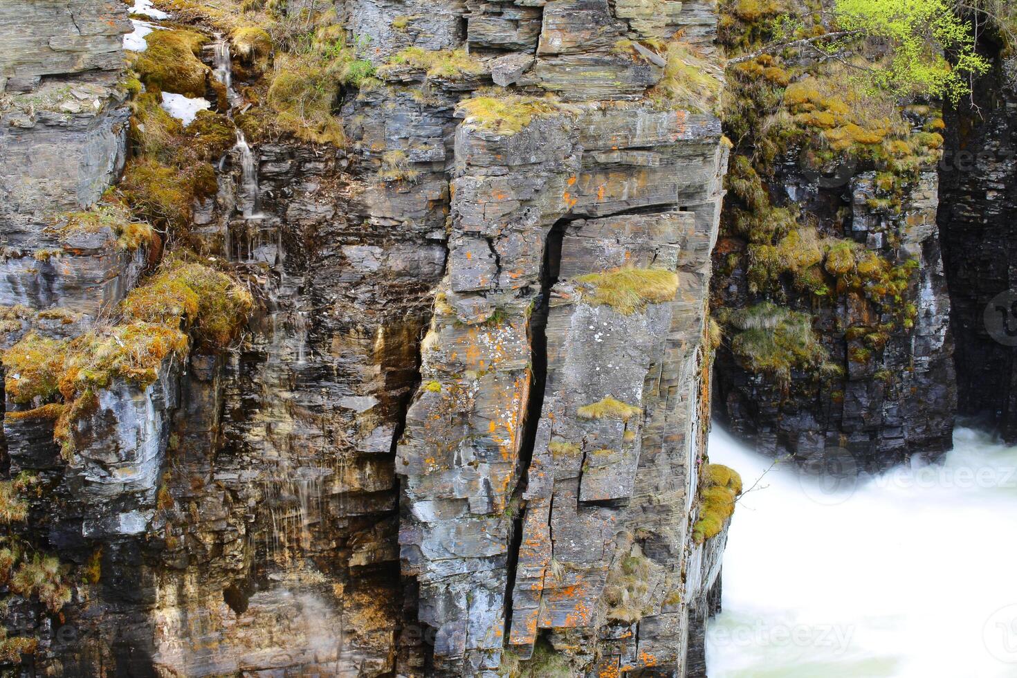 Slate cliffs at the stream Abiskojakka in Sweden photo