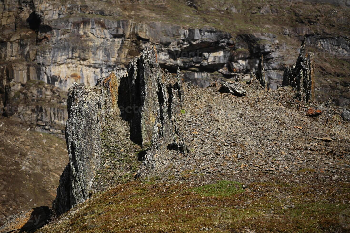 Rock formation resembling a dark castle in the valley Karkevagge in northern Sweden photo