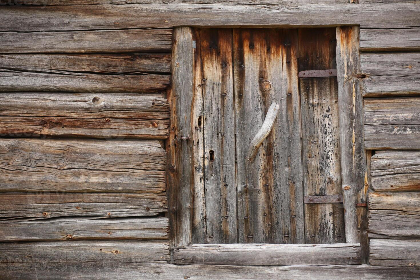 Old and rustic hatch on a log hut photo