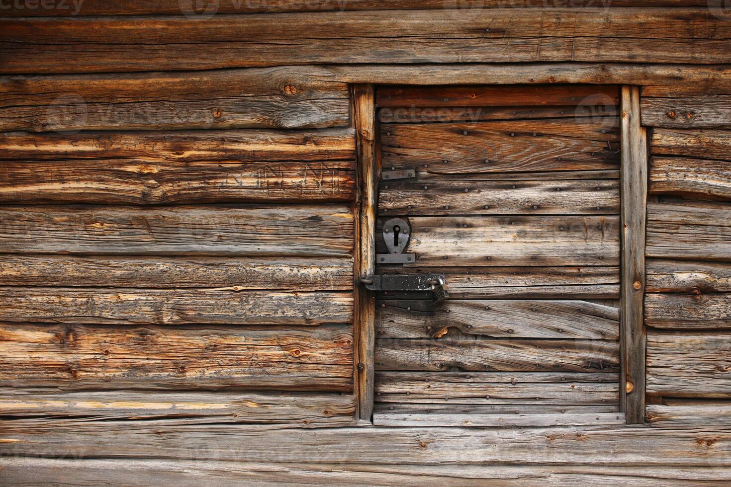 Old and rustic hatch on a log hut photo