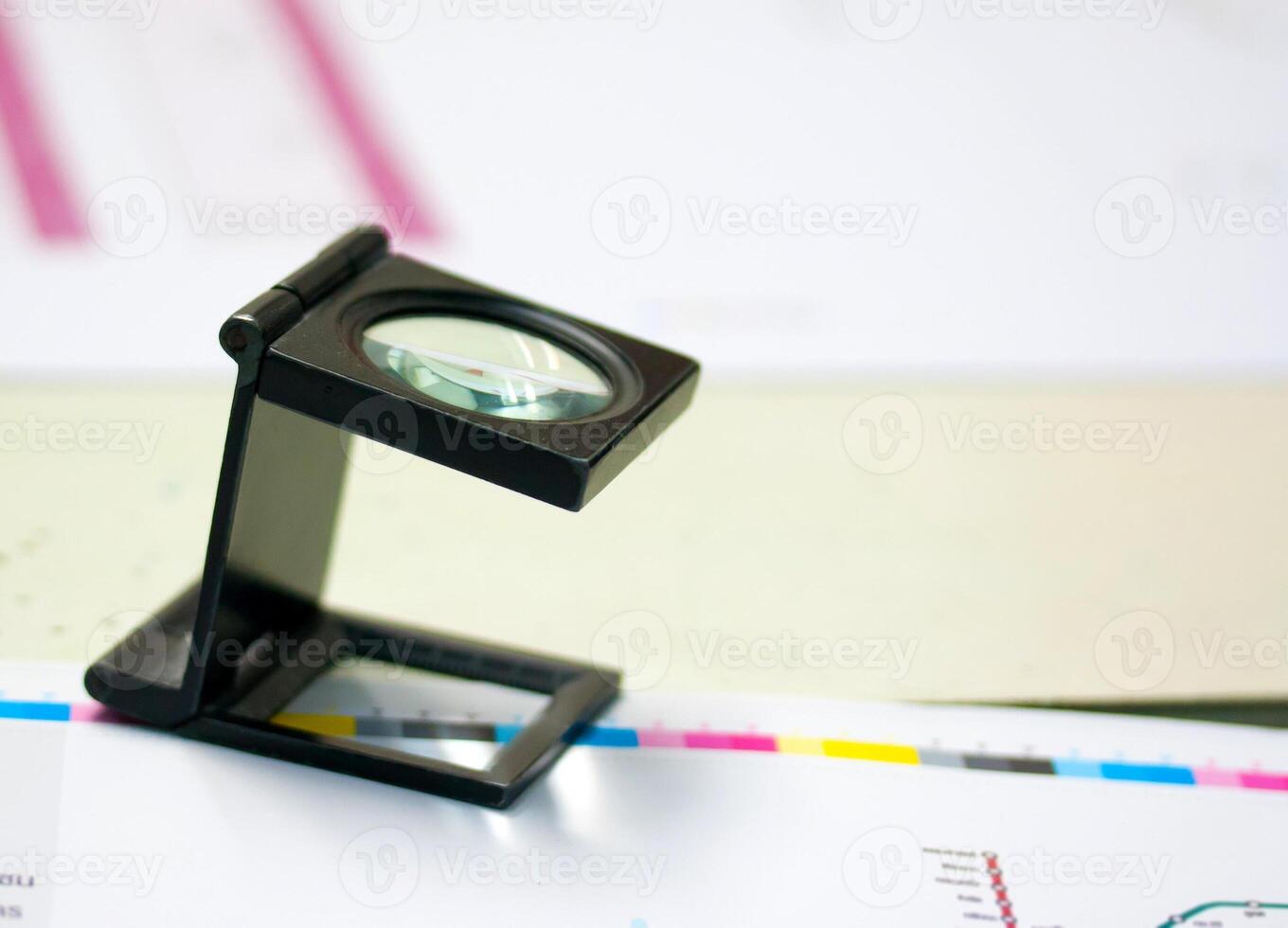 A magnifying glass on top of a table photo