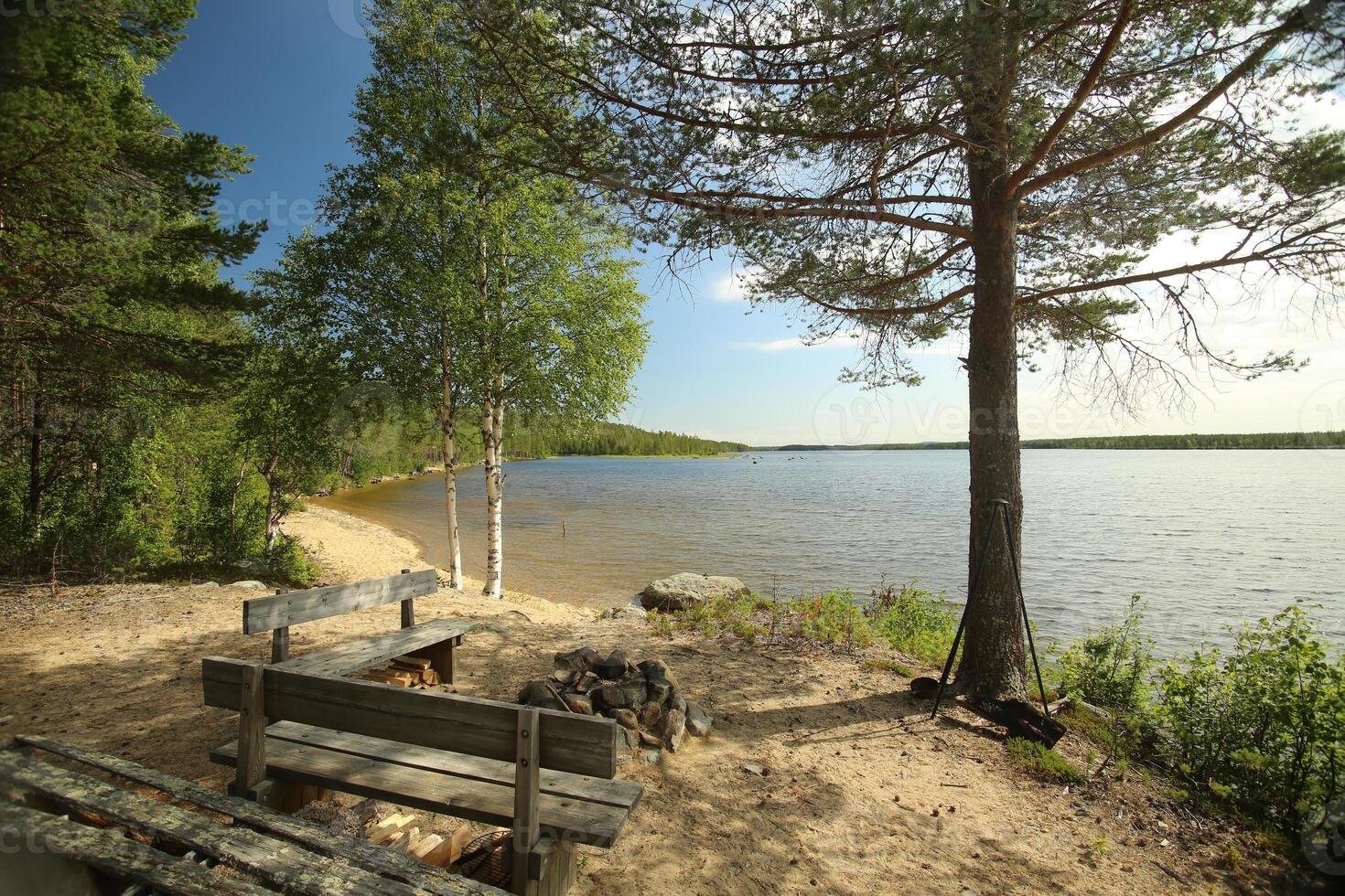 Sand beach at lake Vargforsdammen, a reservoir in the stream Skelleftealven in Northern Sweden photo