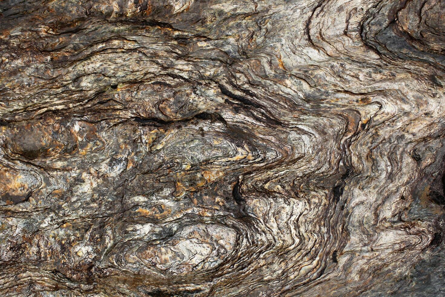 Layers of slate stone eroded by water photo