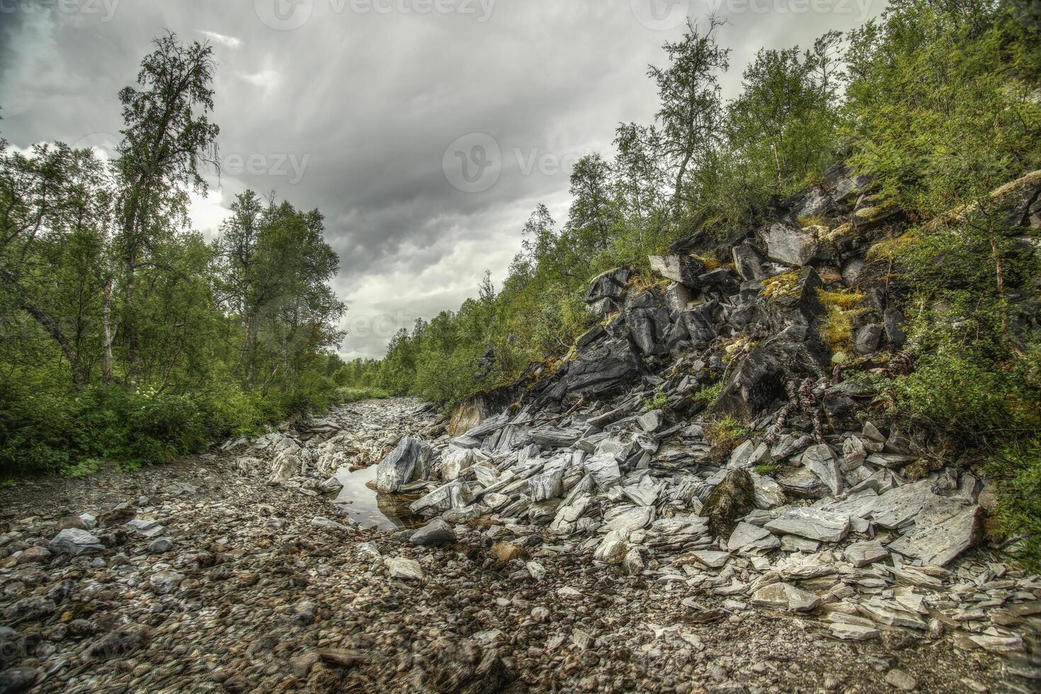 River bed of the stream Renselelva near the cave Marmorgrottan in Norway photo