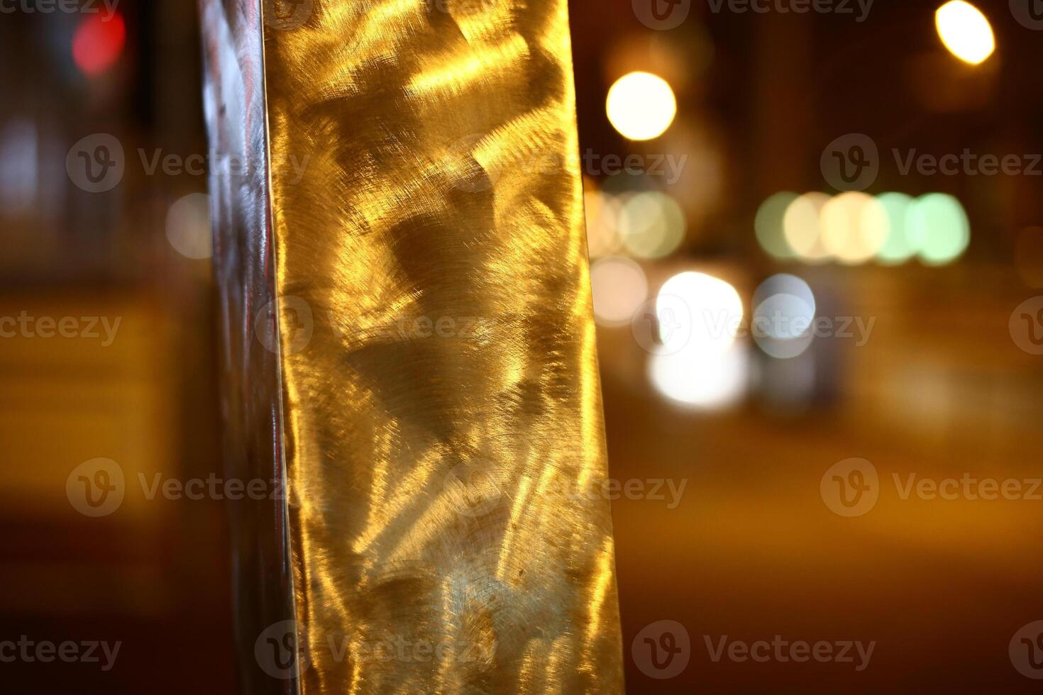 Brushed metal bar in the night with defocused background photo