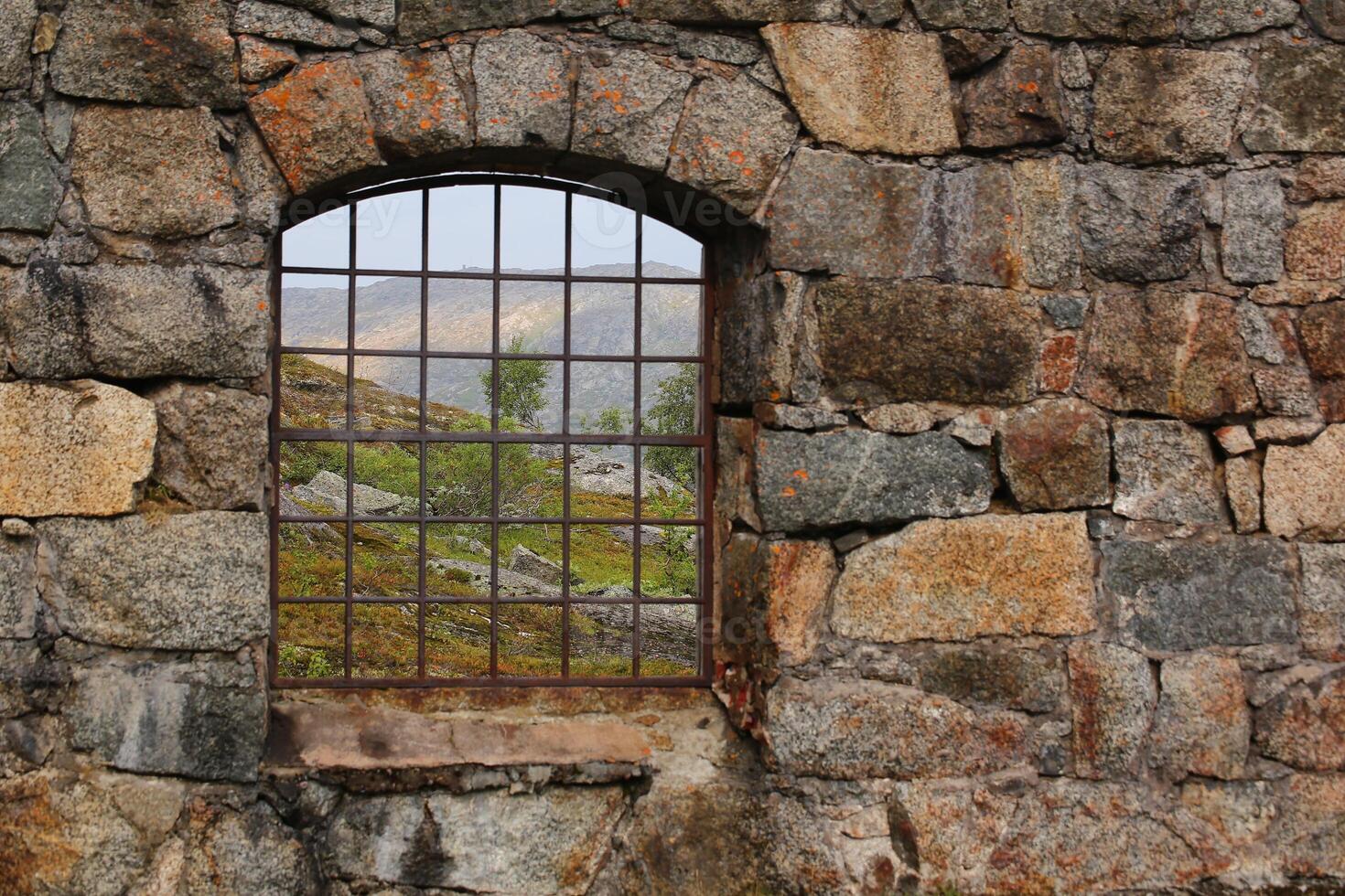 View through the barred window of an old railway turntable at Riksgransen in Sweden photo