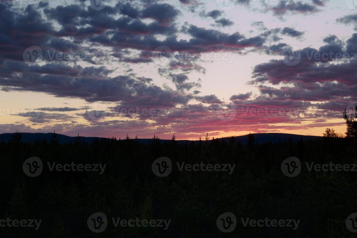 Dusk and pink colored clouds over the mountains Bredtraskliden and Svartliden in southern Lapland photo