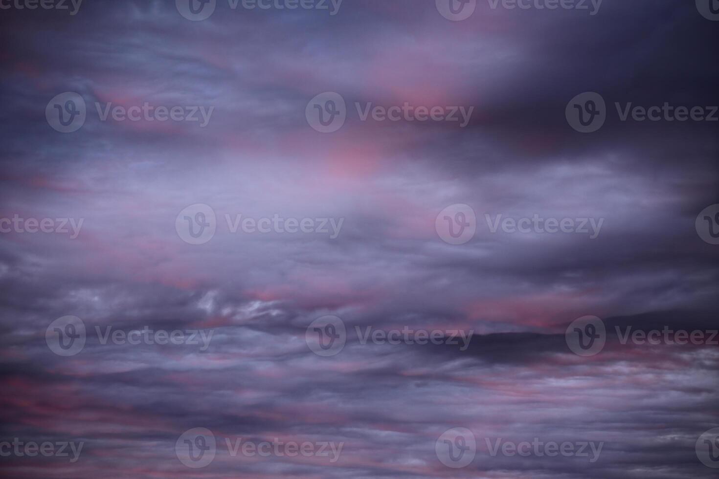 Impressive cloudscape, lightly illuminated by the sun below photo