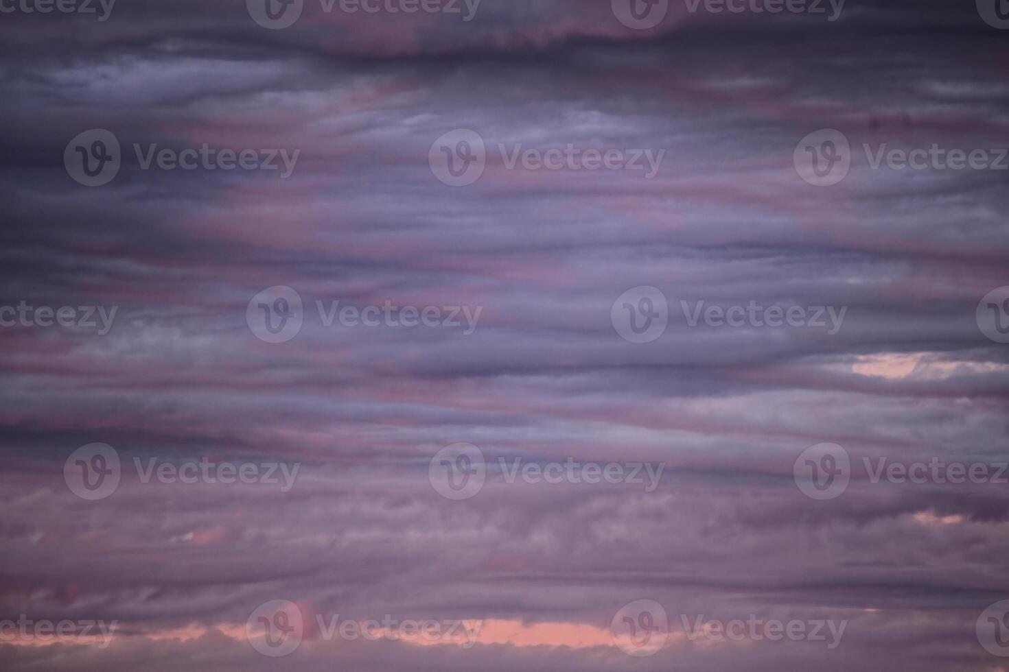 Impressive cloudscape, lightly illuminated by the sun below photo