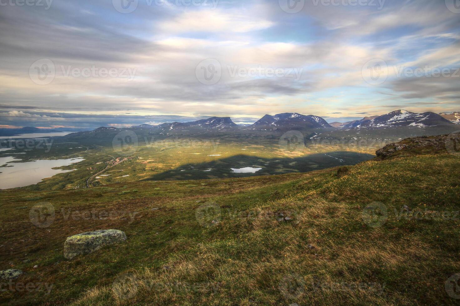 In summer nights here on Mount Nuolja, the mountain casts a shadow on Abisko valley photo