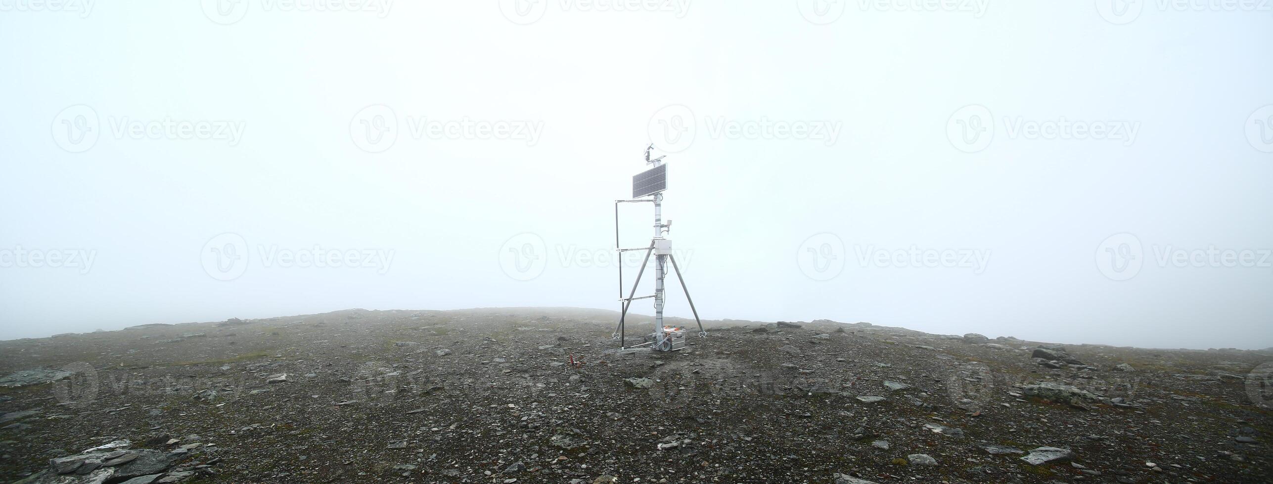 Measuring station in the fog on top of Mount Nuolja in Sweden photo