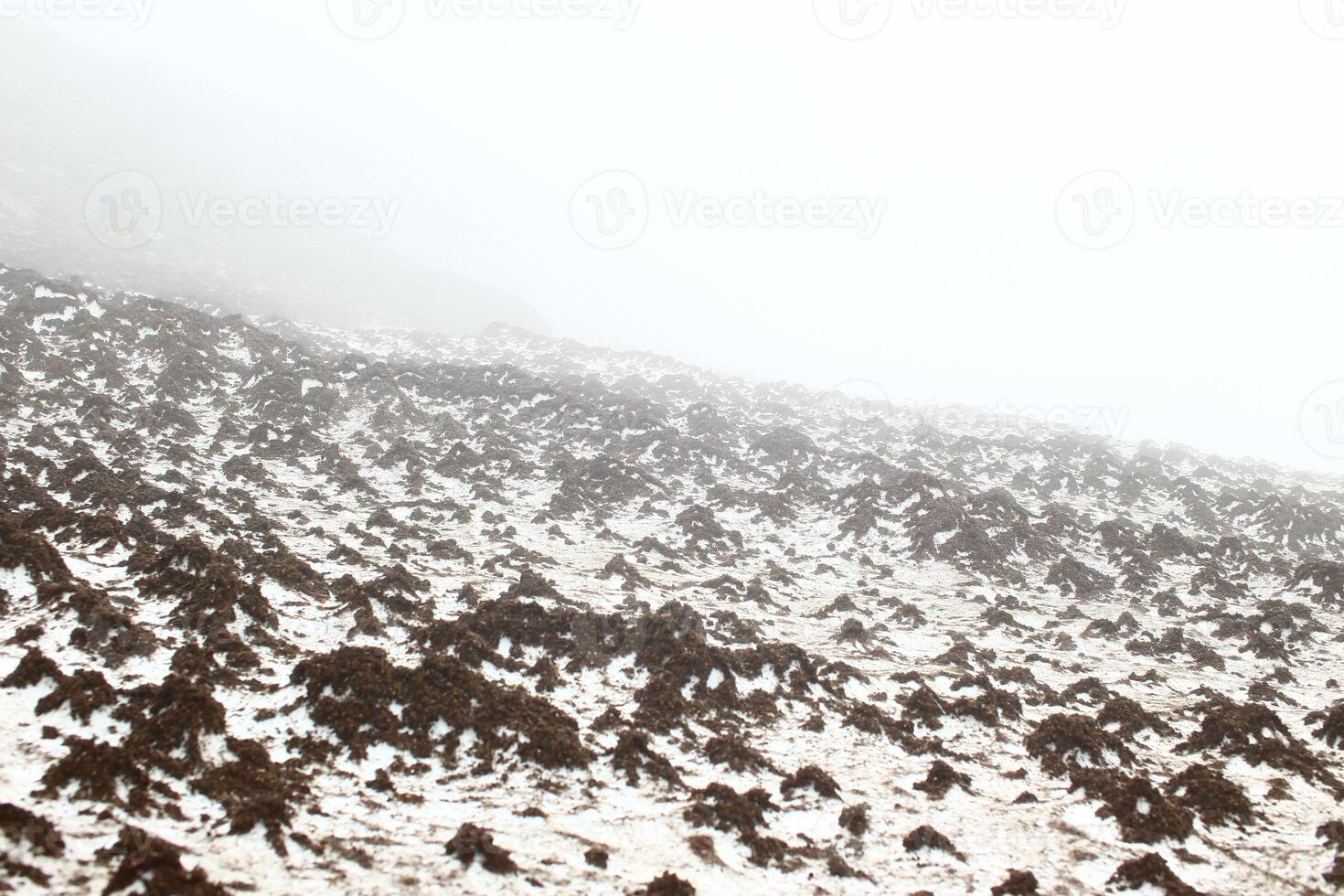 Dirty melting snow on mount Nuolja in northern Sweden photo