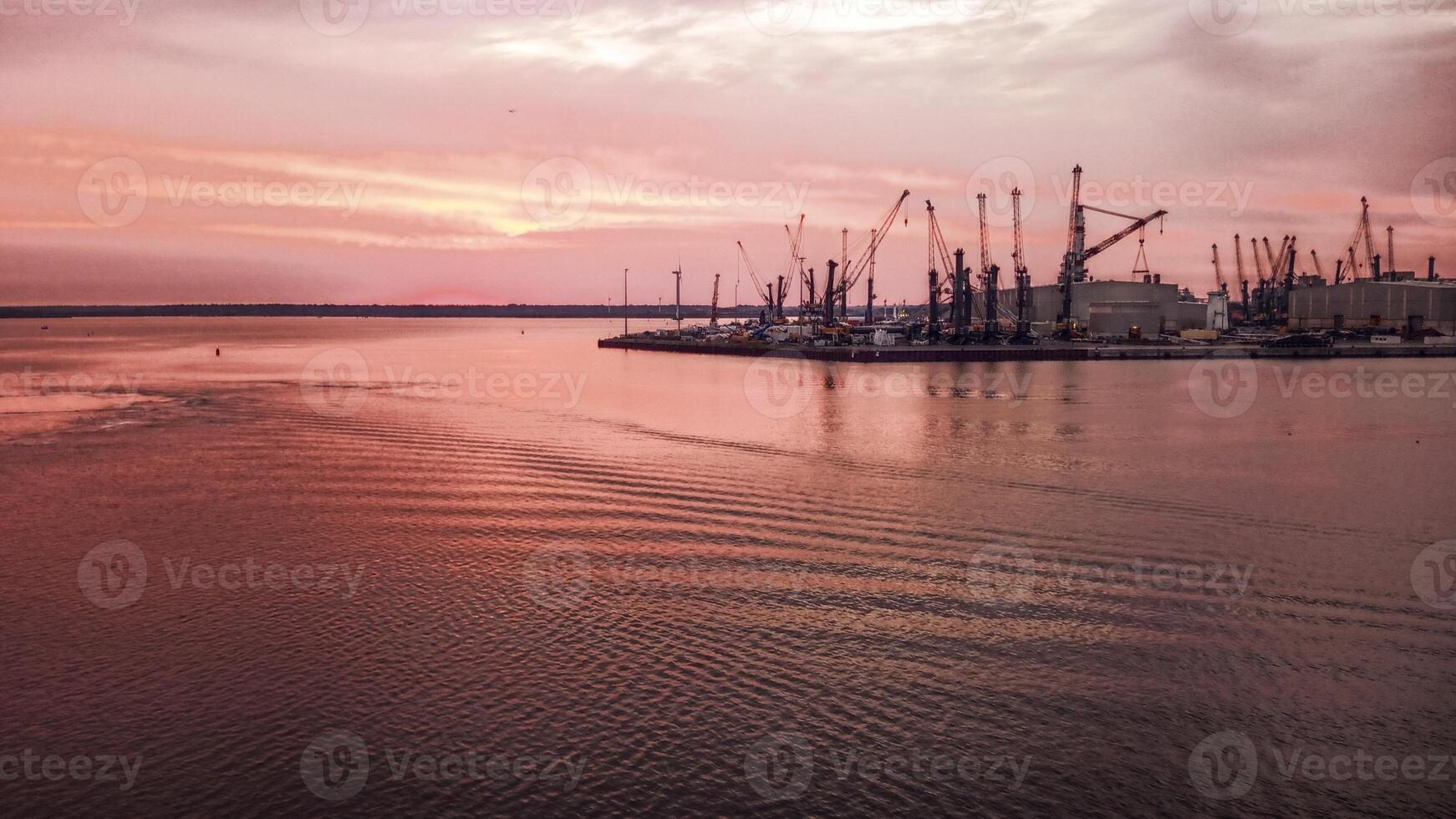 Industrial port in Rostock with cranes in dawn photo