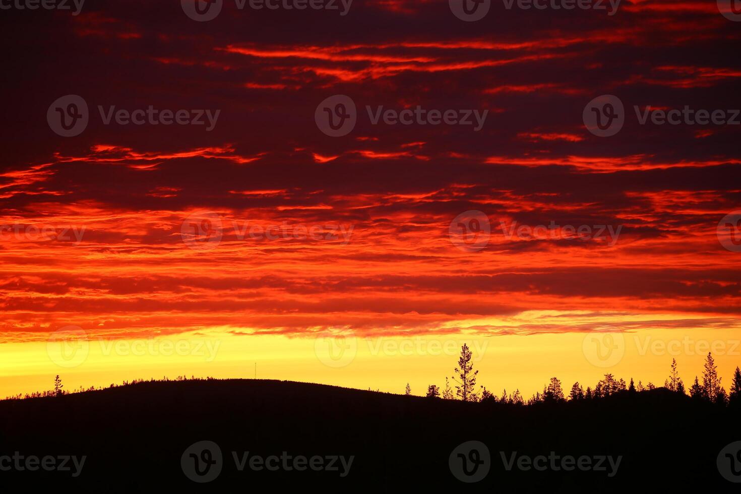 Impressive cloudscape, over the silhouette of mountain and tree photo