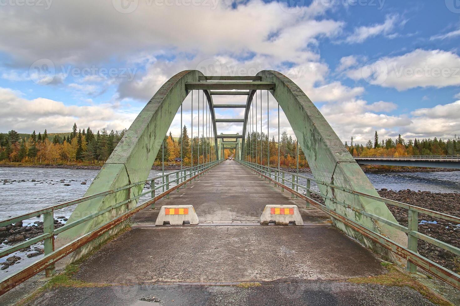 Old bridge crossing Pite river at Ljusselforsen in Lapland photo