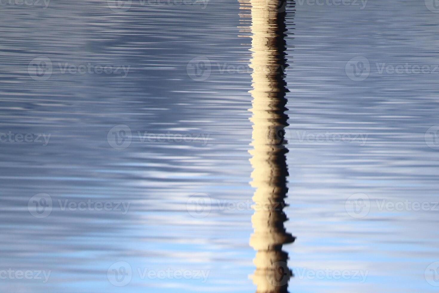 Reflection of concrete pillar on lake Menstrask photo