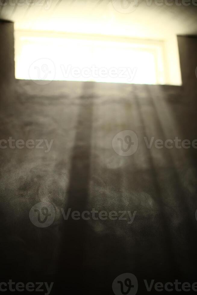 Rays of sunlight illuminating dust in basement photo