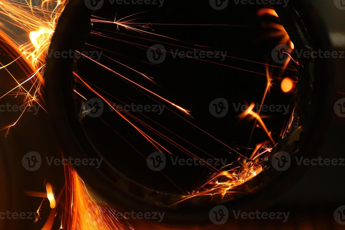 Cutting a metal pipe with angle grinder photo