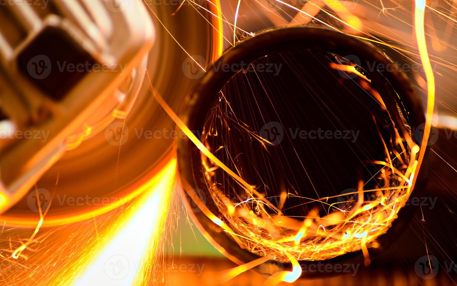 Cutting a metal pipe with angle grinder photo