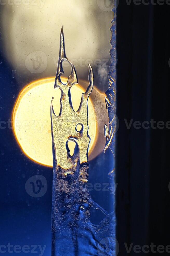Detail of ice crystals on frozen window in backlight photo