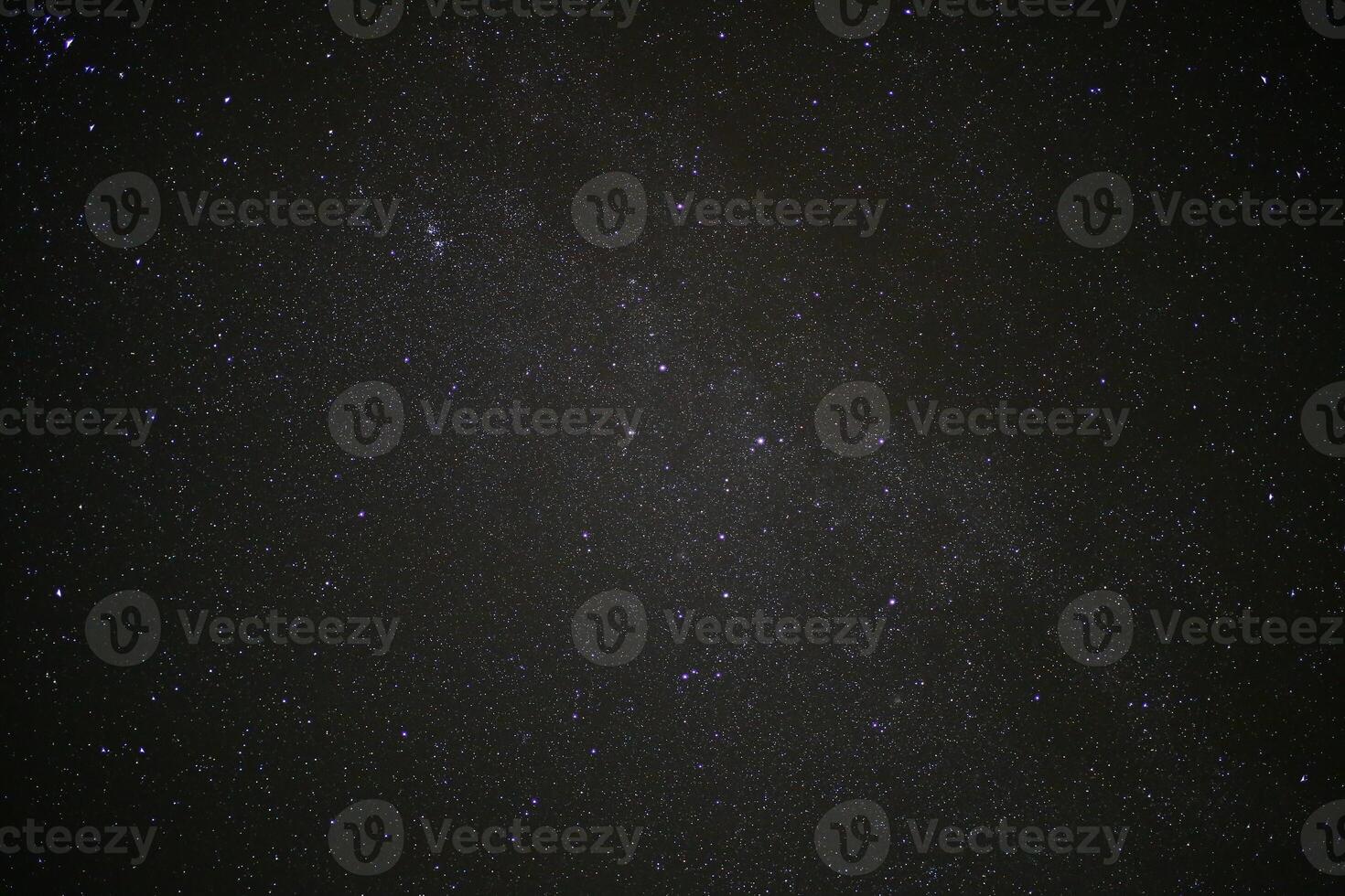 Long exposure of moving clouds on starry sky photo