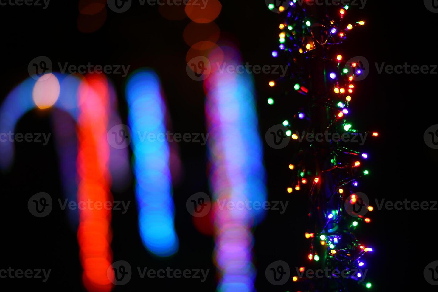 Abstract shot of string lights becoming blurry color spots photo