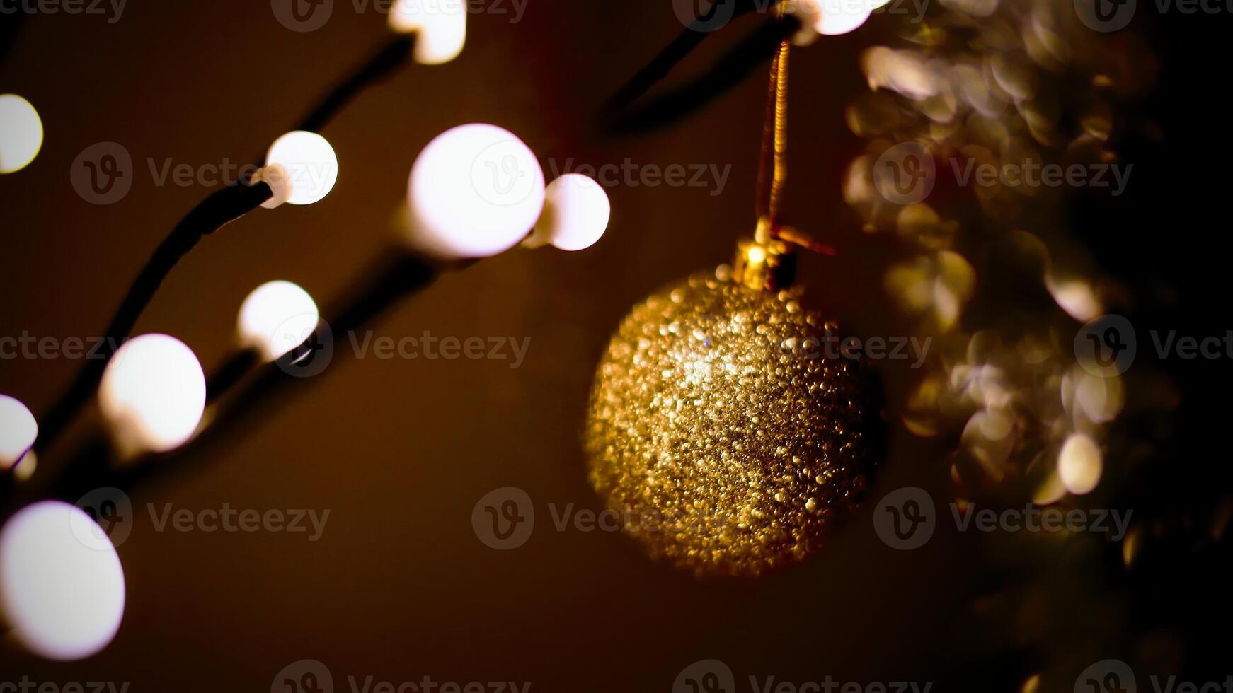 Close-up of golden sparkling christmas tree ball photo