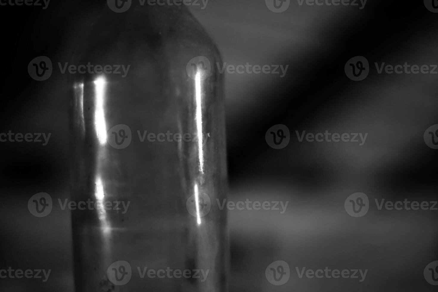 Monochrome shot of an empty glass bottle photo