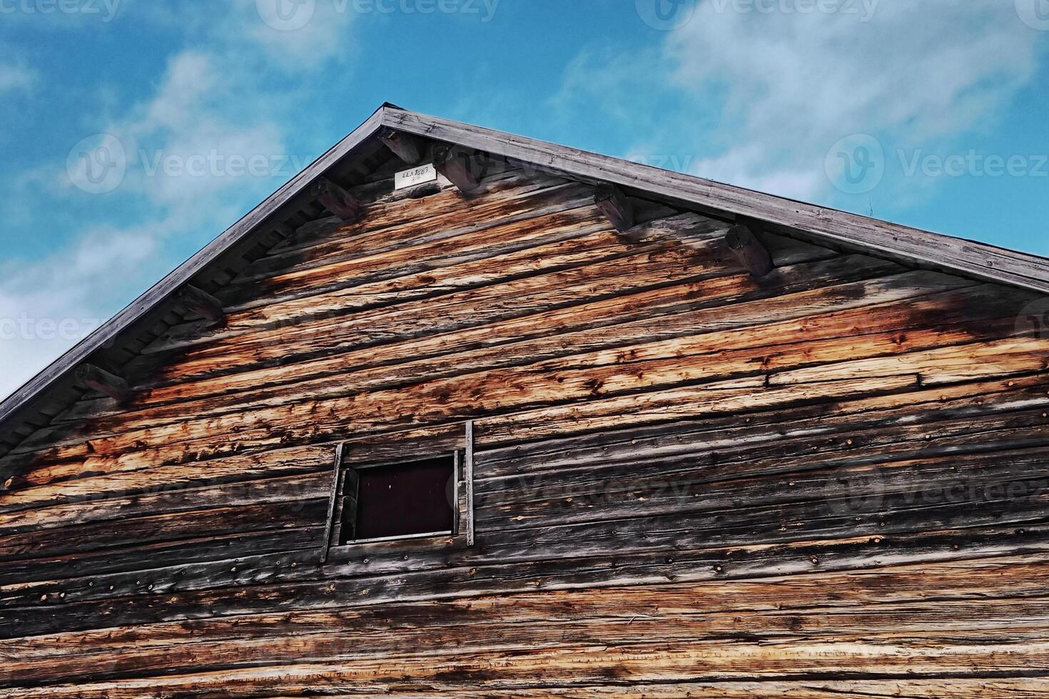 Roof of and old barn in Swedish Lapland, a sign with the construction date 1887 can be seen at the top photo