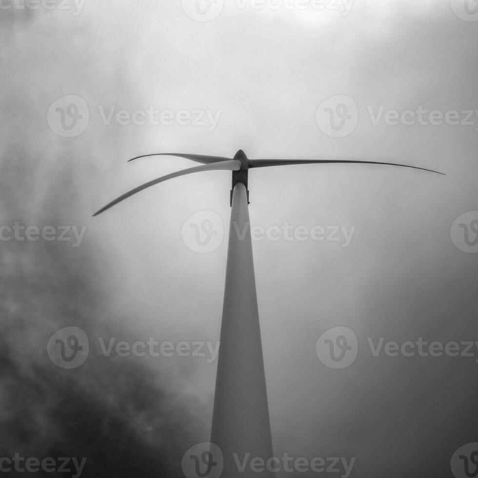 Monochrome shot of wind turbine and clouds photo