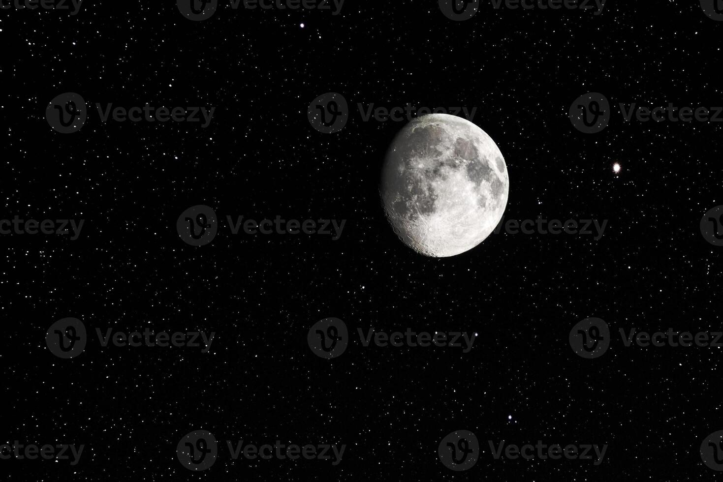 Waxing gibbous moon and stars on a clear sky photo