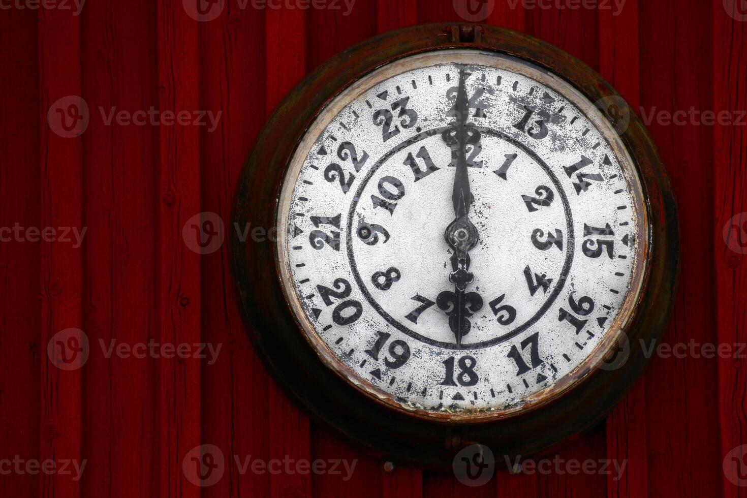Old clock on a red wooden wall photo