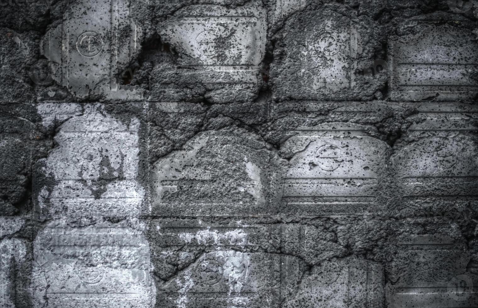Damaged wall with impressions of old tiles photo