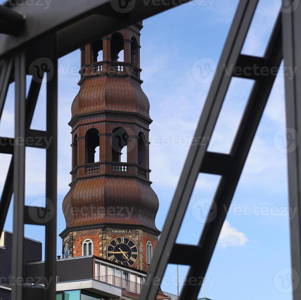 Hamburger Michel, St Michaels church in Hamburg, with defocused steel bridge frame in foreground photo