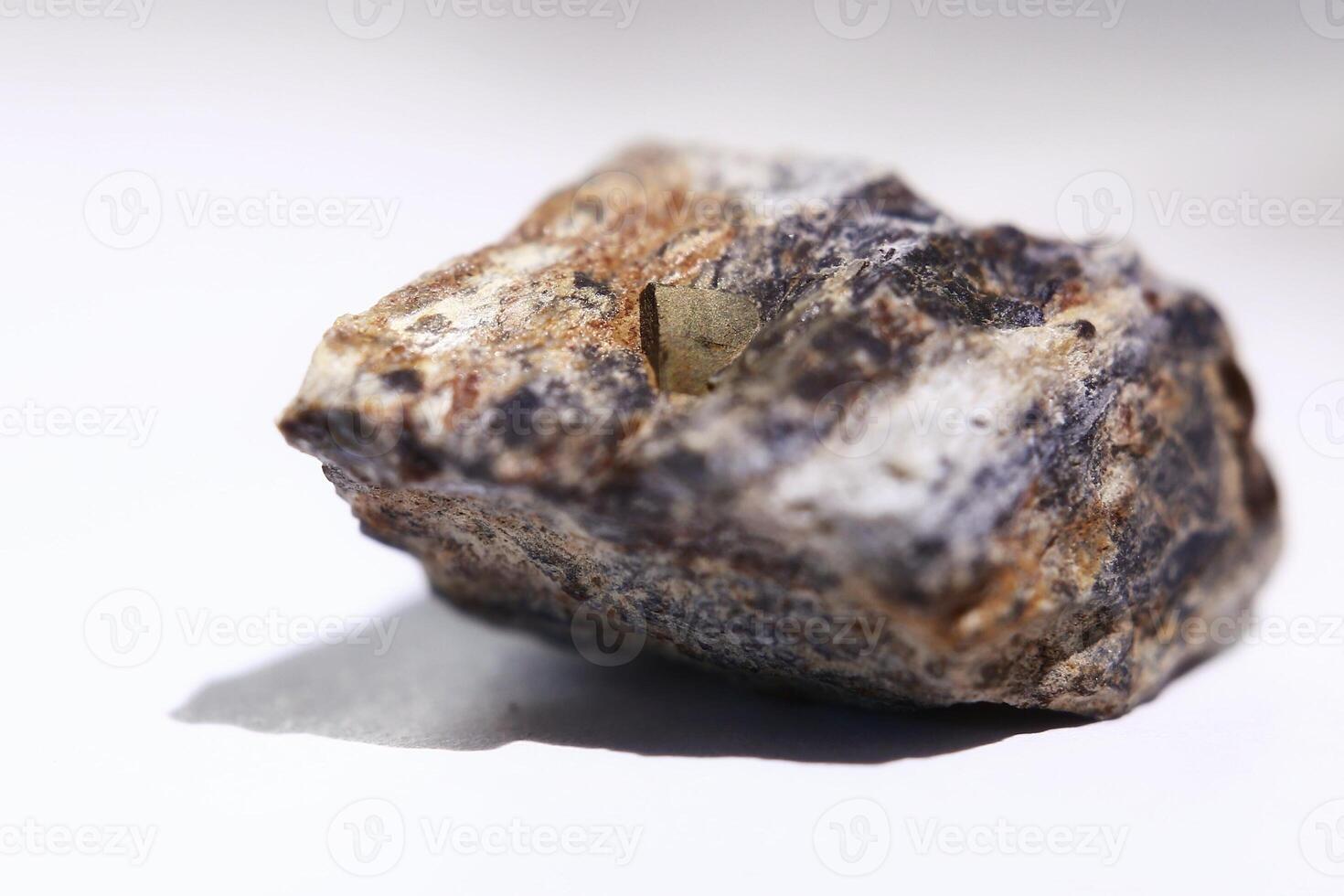 Macro of pyrite crystal fools gold in a rock, isolated on white photo