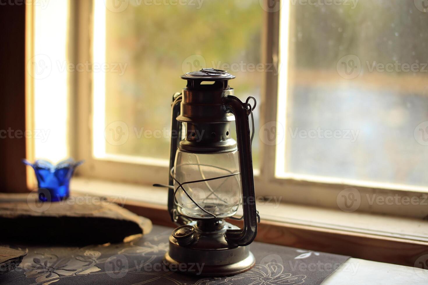 Close up of an oil lamp at the window photo