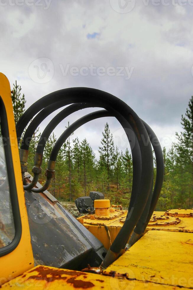Hydraulic tubes of an old and rusty excavator photo